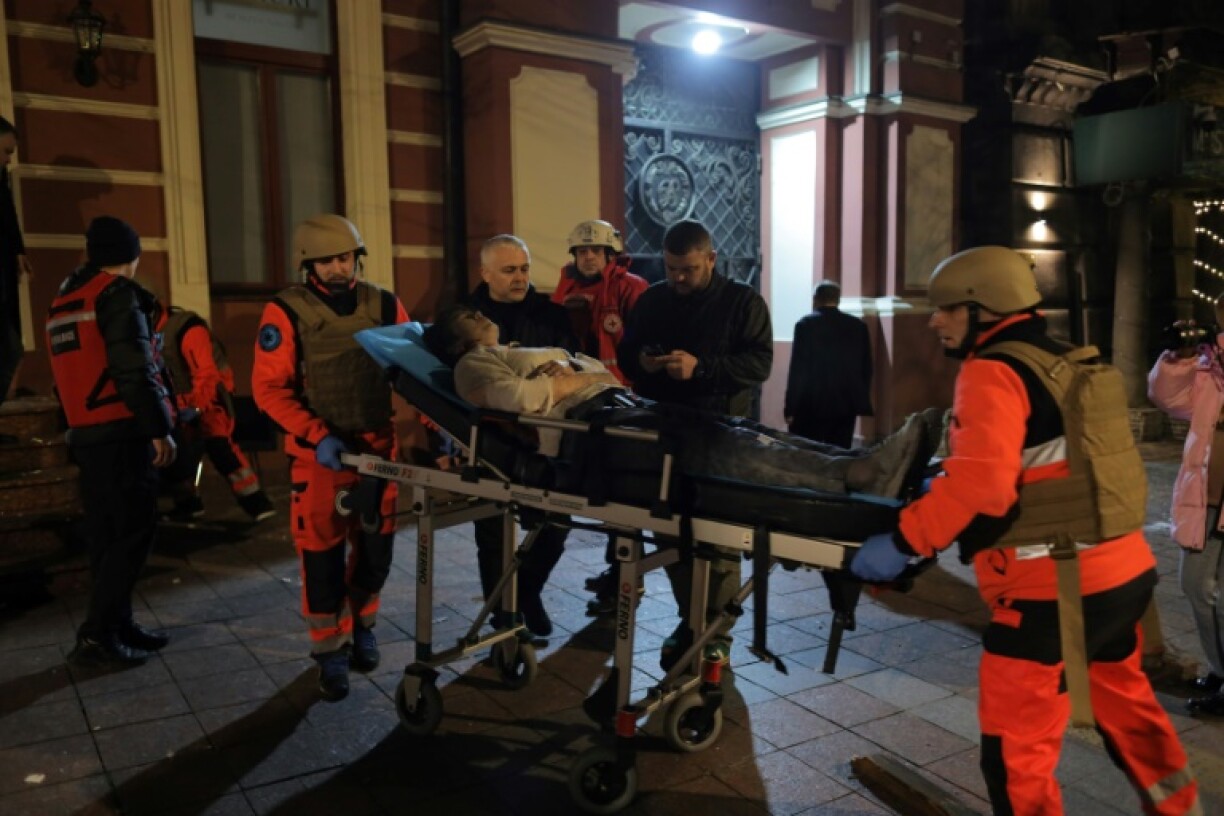 Rescuers evacuate one of the wounded after the missile attack in Odesa