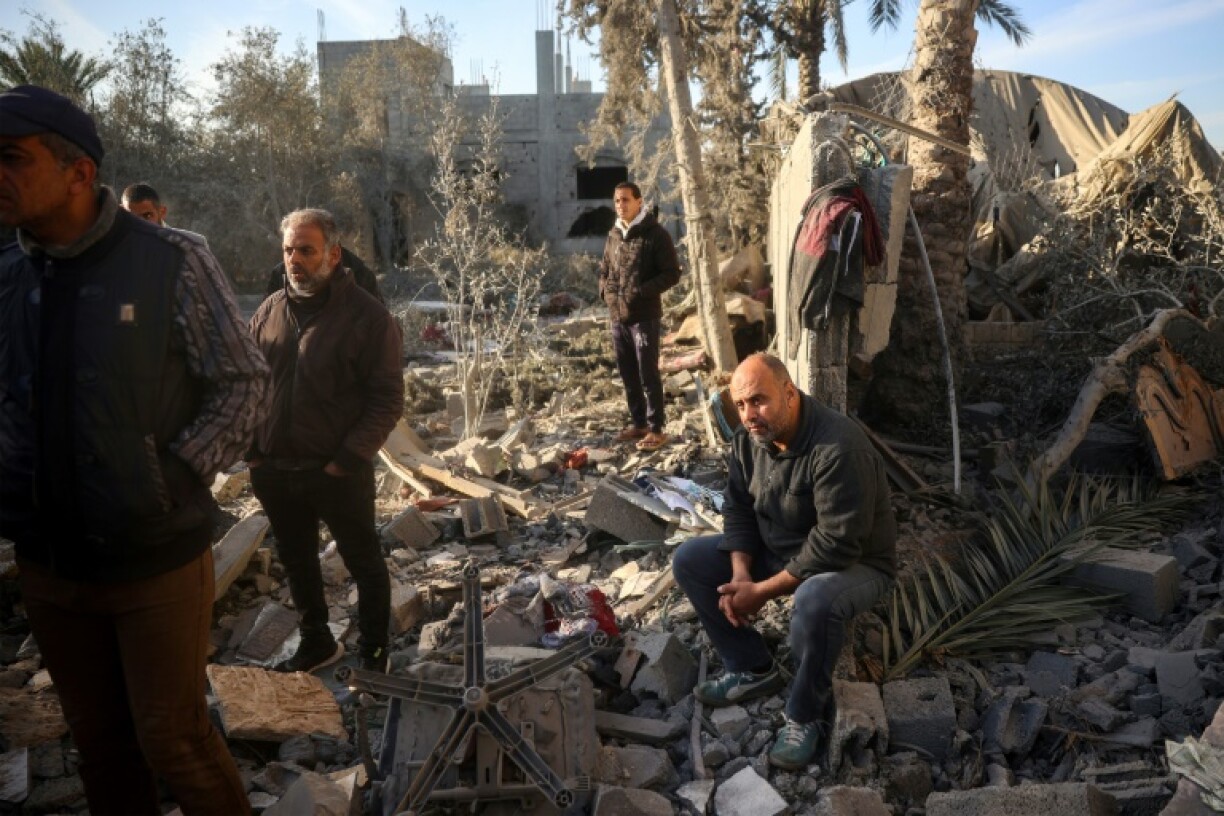A relative of the Abu Samra family looks on as Palestinians search for survivors after a strike on their home in central Gaza