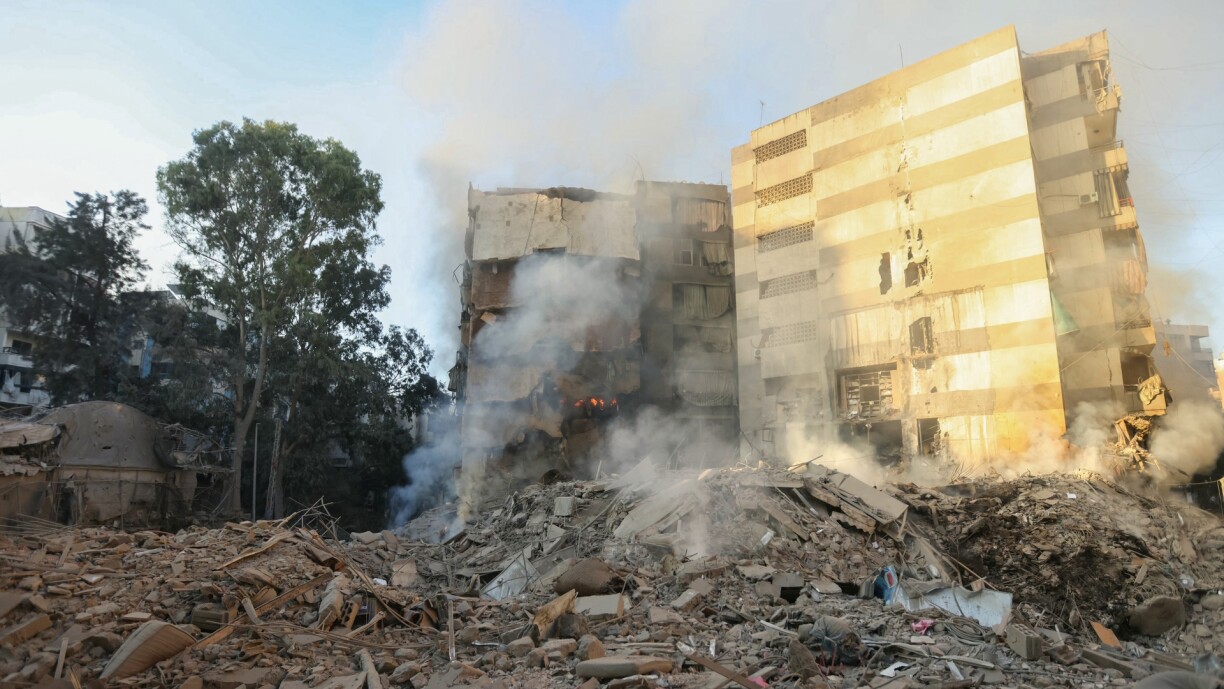 Smoke billows from building rubble at the site of overnight Israeli airstrikes on the Mreijeh neighbourhood in Beirut's southern suburbs on 4 October.