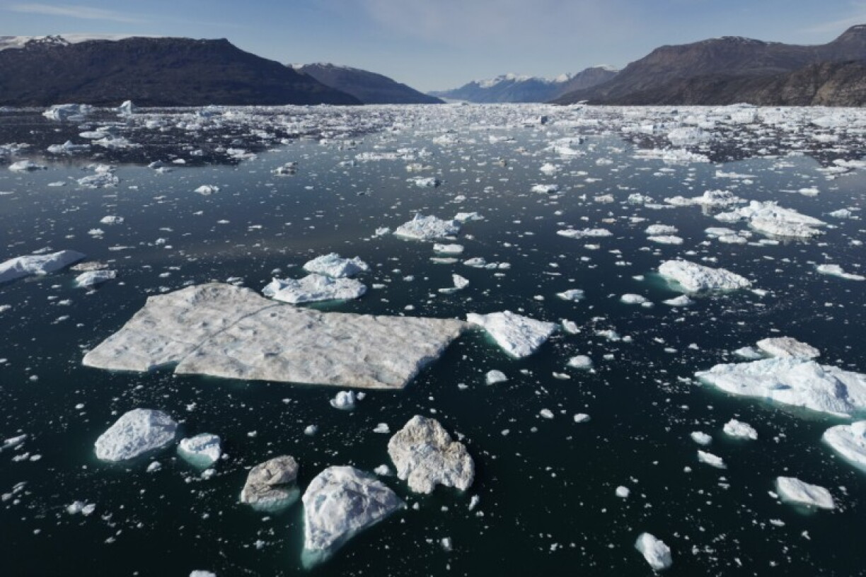 This photograph taken on August 16, 2023, shows different sizes of icebergs drifting as they melt due to warm temperatures along the Scoresby Sound Fjord, in Eastern Greenland