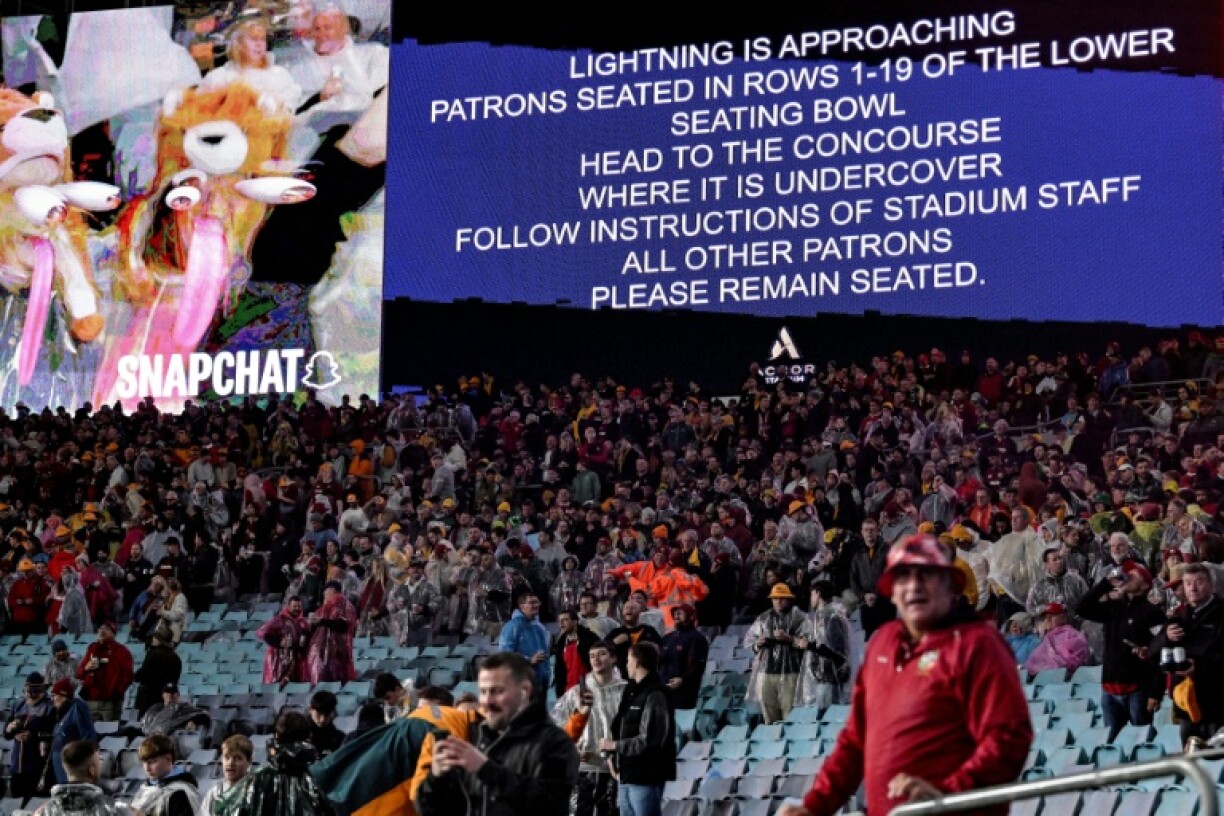 A public announcement warns of lightning during the third rugby Test match between Australia and the British and Irish Lions at Stadium Australia in Sydney