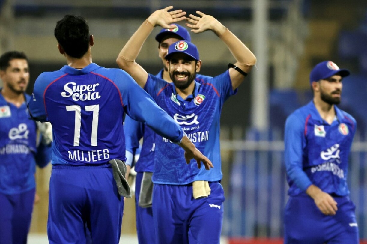 Afghanistan's Karim Janat celebrates after taking the wicket of UAE captain Muhammad Waseem