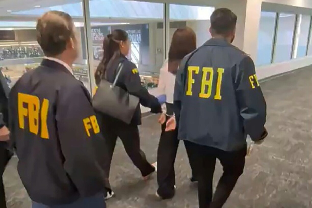 Video footage shows FBI agents arresting Wanying Zhang, 34, who is accused of spying on Taiwanese President Lai Ching-te's son and his family