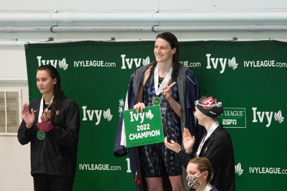 Former University of Pennsylvania transgender swimmer Lia Thomas (center) smiles after winning a race in 2022