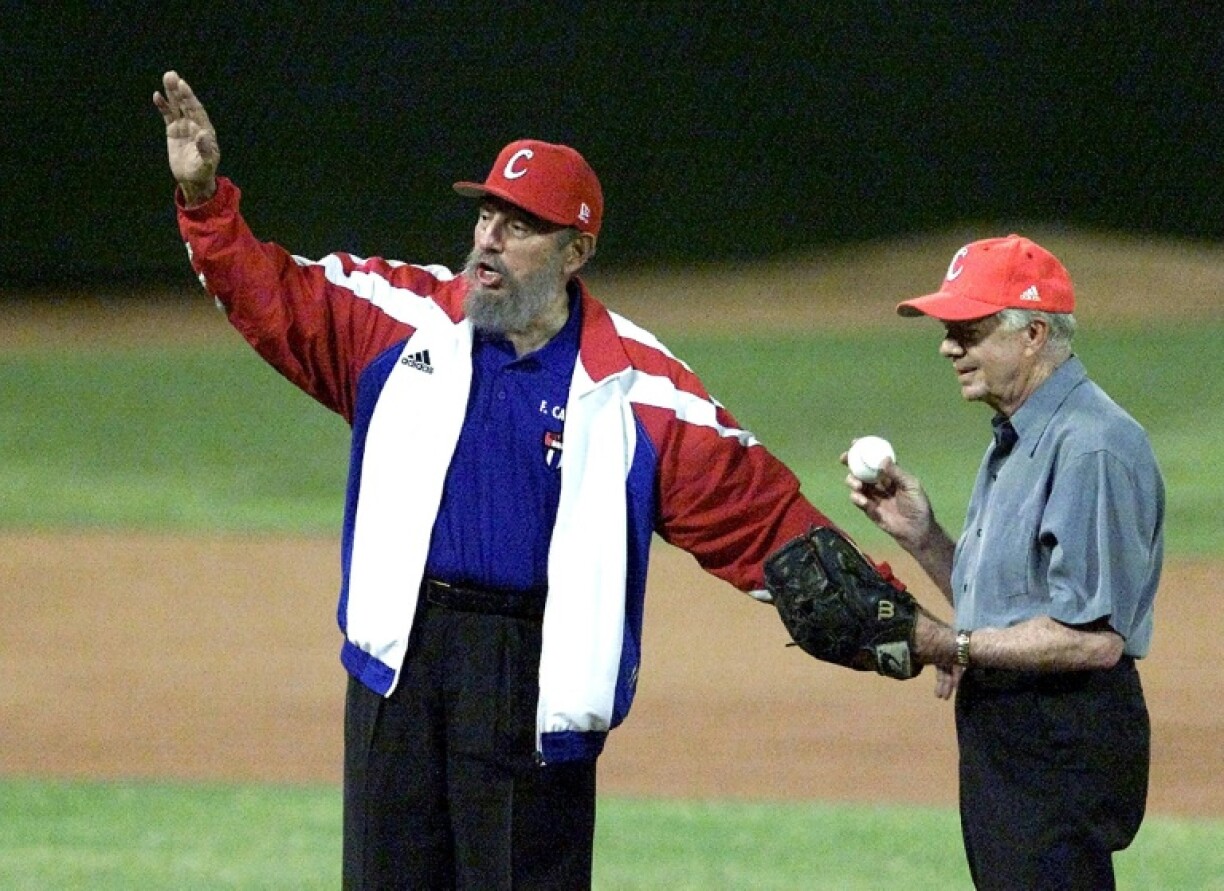 Cuban president Fidel Castro (L) calls for time as former US president Jimmy Carter (R) prepares to throw out the ceremonial first pitch in a baseball game in May 2002 in Havana