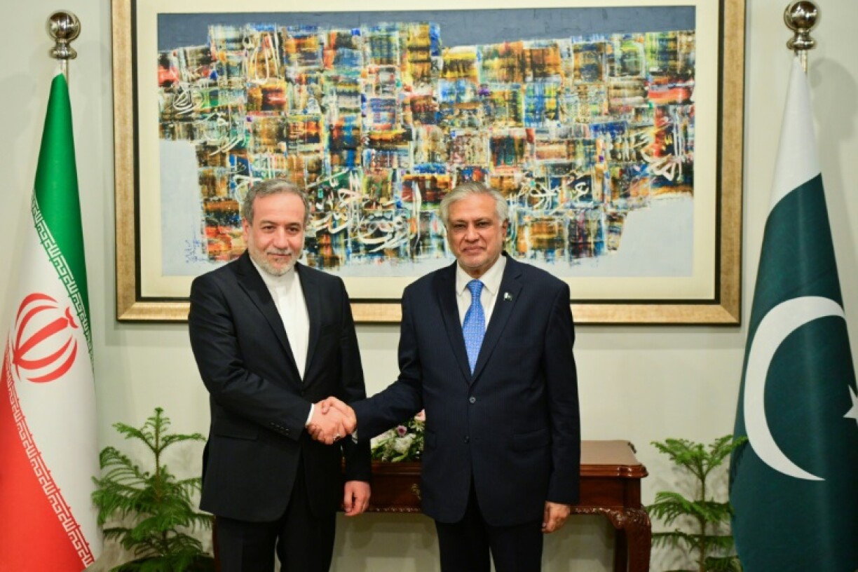 Pakistan's foreign minister Ishaq Dar (R) shaking hands with his Iranian counterpart Abbas Araghchi in Islamabad
