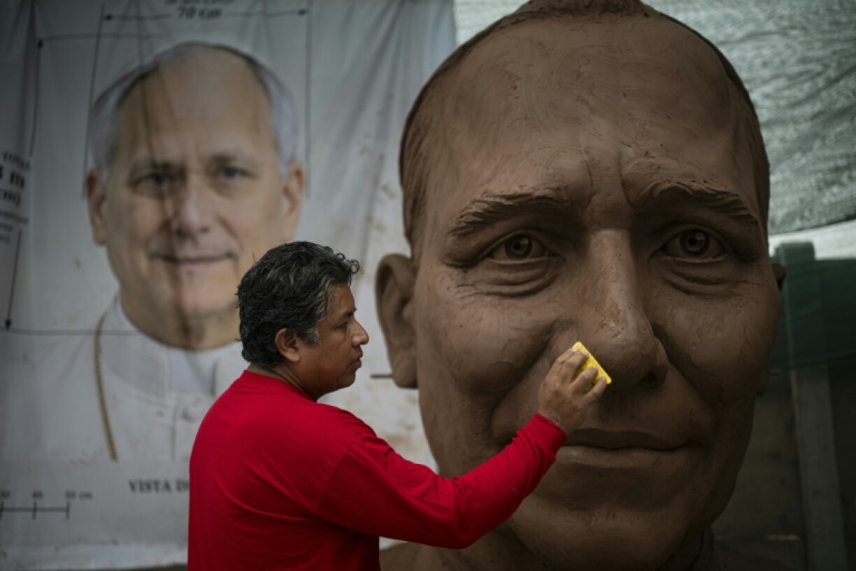 A giant clay sculpture of Pope Leo XIV's head takes shape in a workshop in northern Lima
