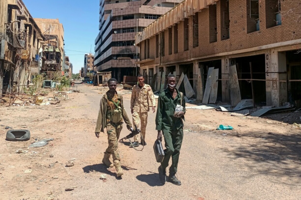 Fighters loyal to the army patrol a market area in Khartoum