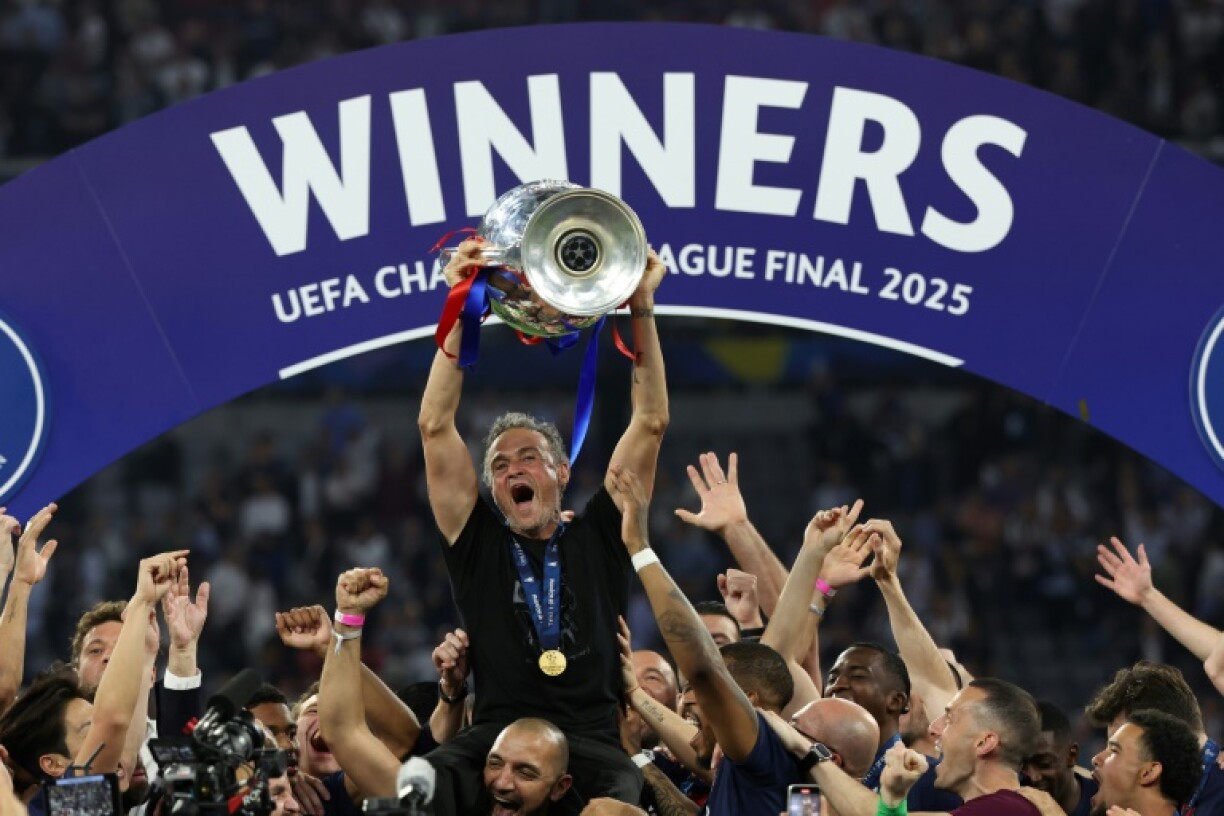 Paris Saint-Germain coach Luis Enrique lifts the Champions League trophy after his side outclassed Inter Milan in the final