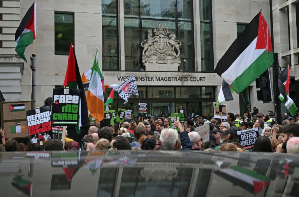 Supporters of the Irish rap band Kneecap fly Palestinian flags outside Westminster Magistrates' Courts in London
