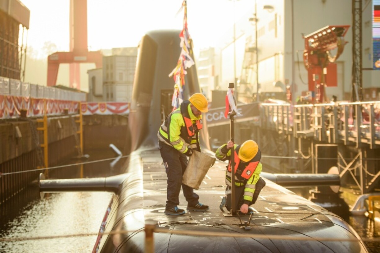 Workers at the thyssenkrupp marine systems shipyard ahead of the christening of a submarine for Singapore's navy, in Kiel, northern Germany, on December 13, 2022