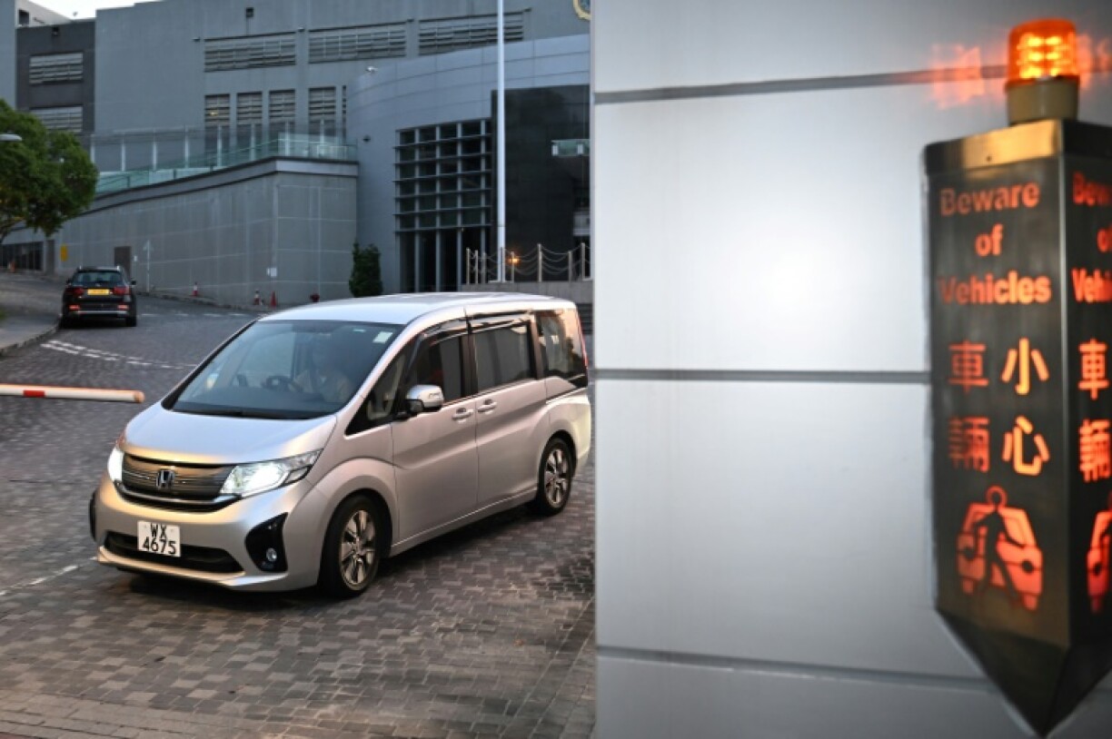 A private vehicle with curtains drawn carrying pro-democracy activist Claudia Mo is seen leaving Hong Kong's Lo Wu Correctional Institution just before sunrise on April 29, 2025