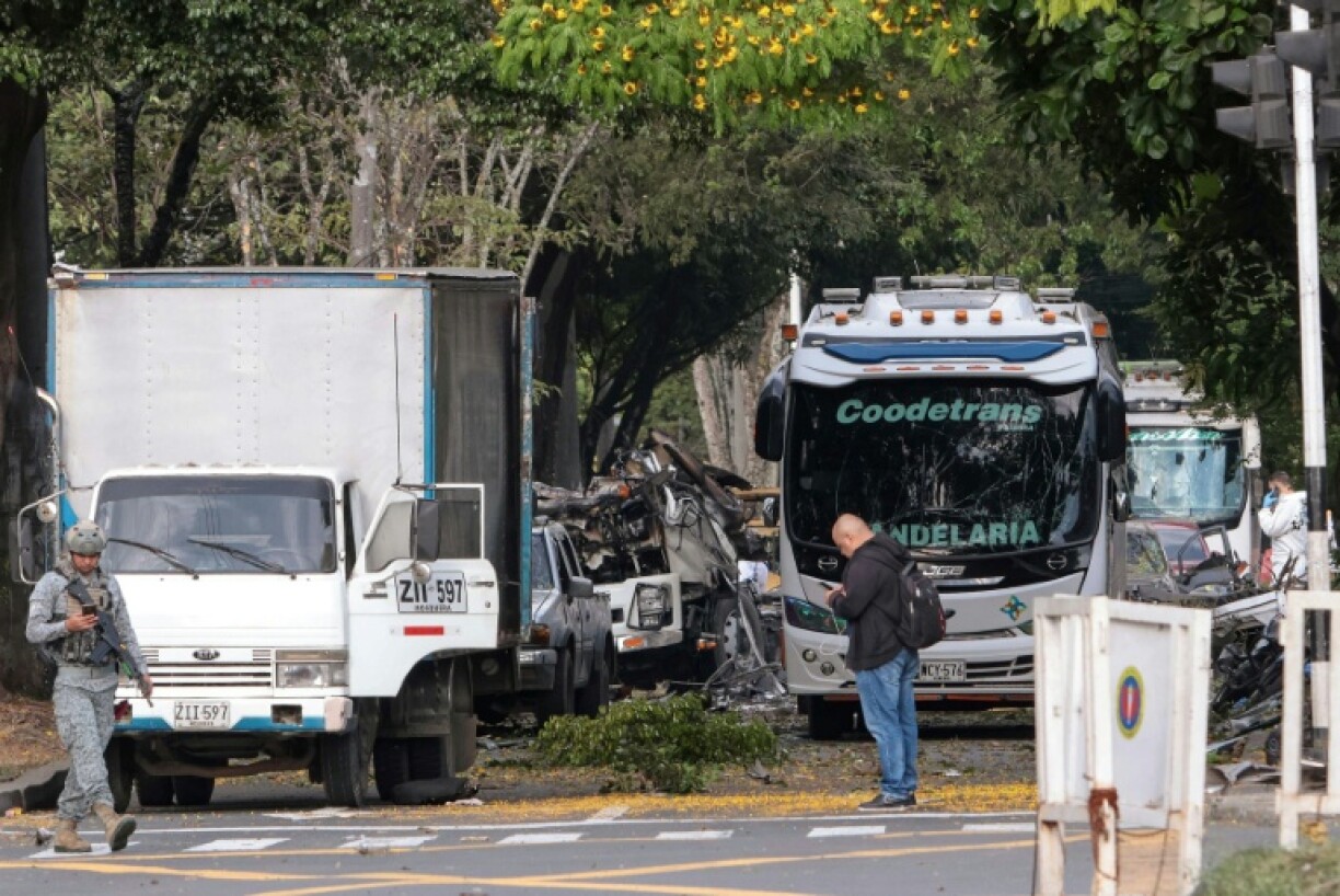 Members of Colombian security forces inspect the area of a bomb explosion in Cali, Colombia, where at least six people were killed and dozens were injured