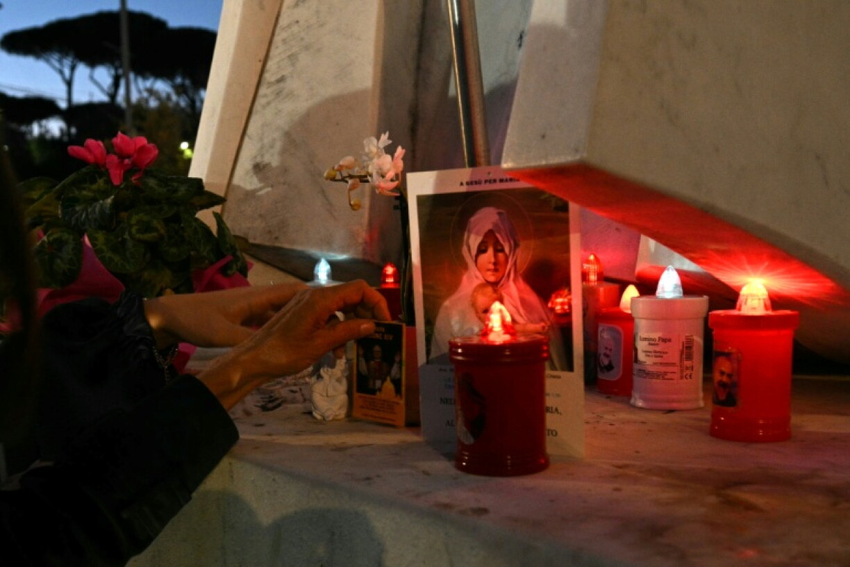 Candles, flowers and prayers are led at the statue of John Paul II outside Rome's Gemelli University Hospital, where Pope Leo XIV was admitted for an operation to remove a lump from his lung