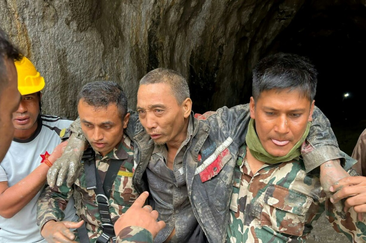 Photo prise et diffusée le 5 septembre 2026 via la page Facebook de l'armée népalaise, montre des agents de sécurité transportant un ressortissant chinois (2e à droite) secouru dans le tunnel d'un chantier hydroélectrique, dans le district de Rasuwa au Népal