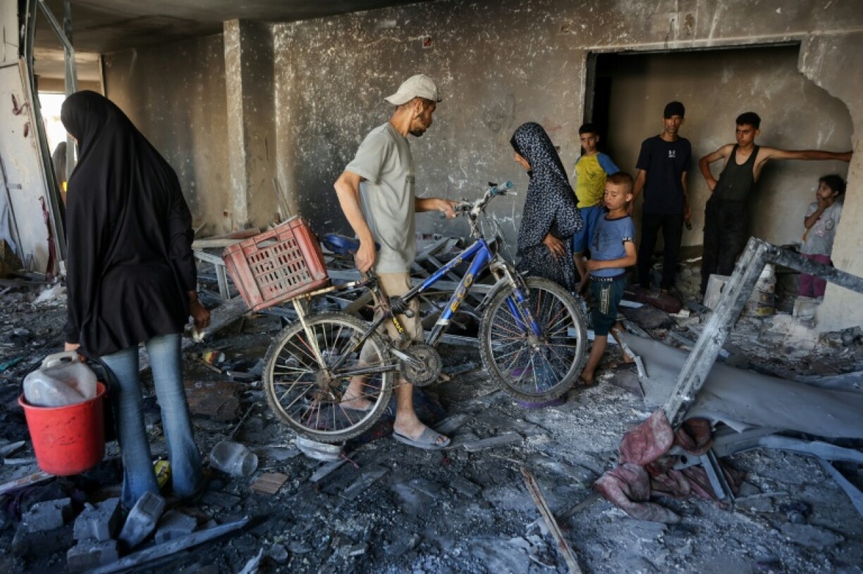 People inspect the damage after a reported Israeli strike on a clinic-turned-shelter in Gaza City