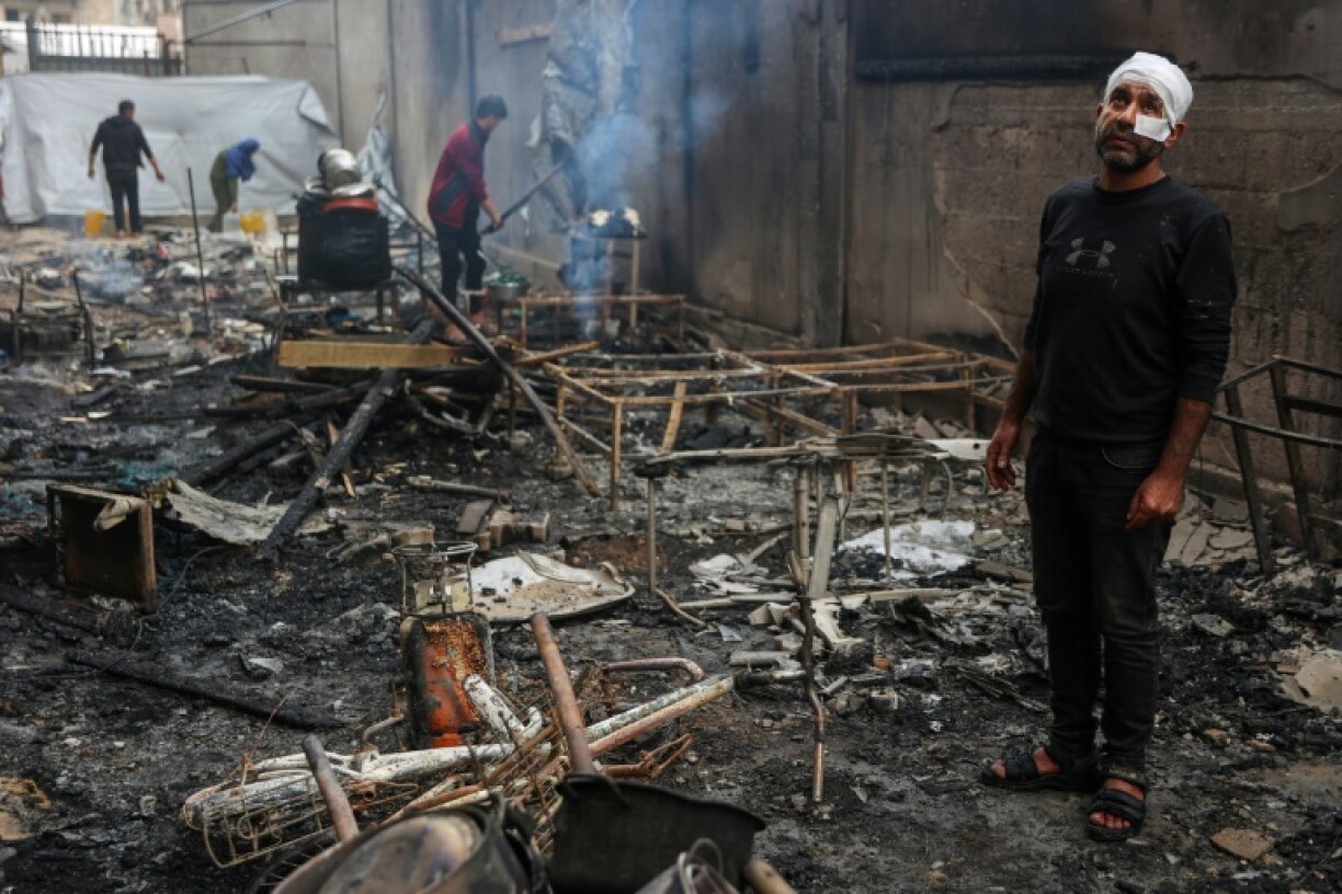Palestinians inspect the damage after an Israeli strike on the Yafa school building, a school-turned-shelter