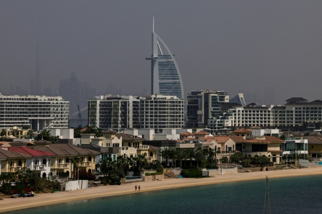 Deux personnes marchent sur une plage de Palm Jumeirah à Dubaï, le 2 mars 2026