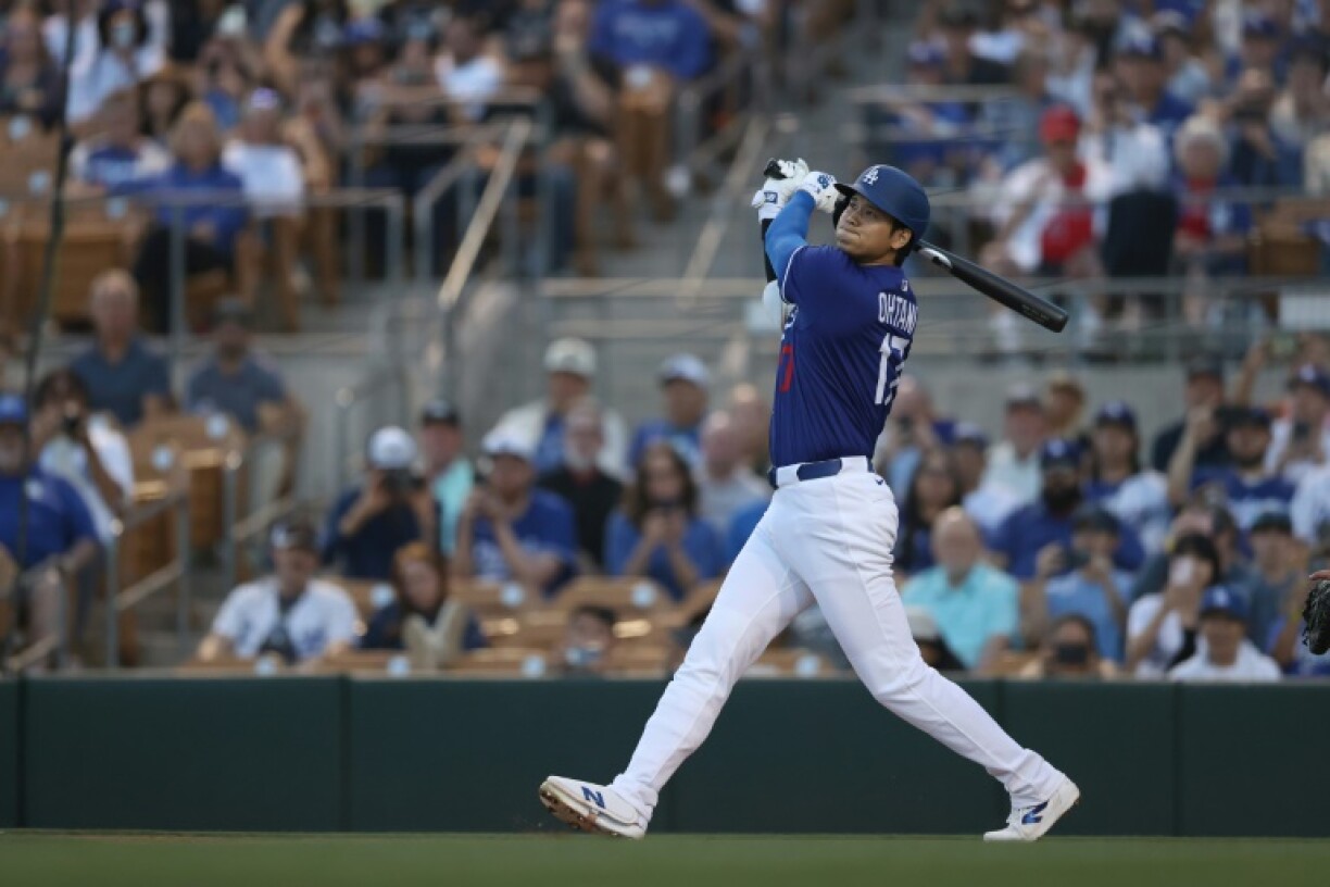 Shohei Ohtani of the Los Angeles Dodgers hits a home run in the first inning of the team's pre-season win over the Los Angeles Angels