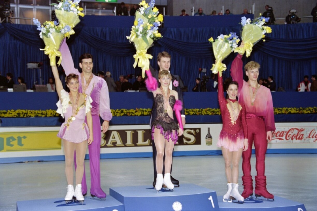 Evgenia Shishkova and Vadim Naumov of Russia (centre) on top of the podium after winning pairs gold at the 1994 world championships in Chiba, Japan