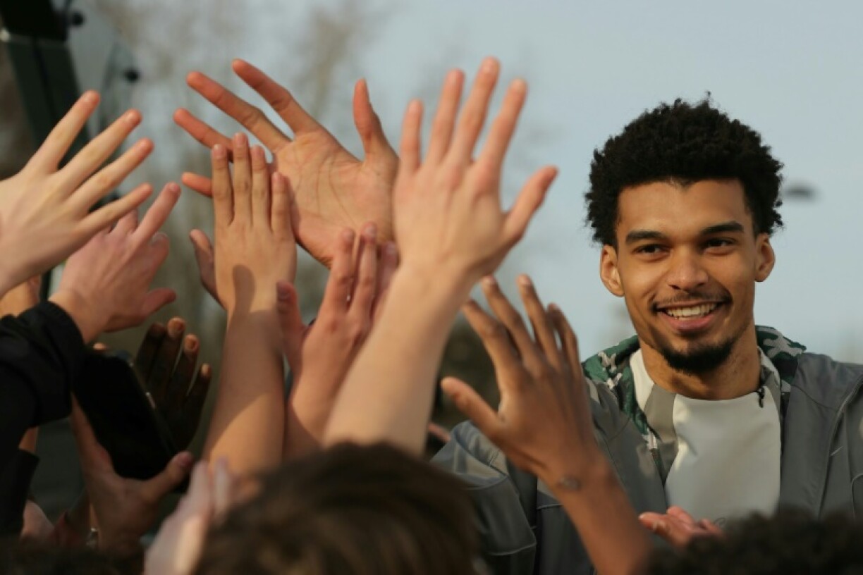 Victor Wembanyama was mobbed by children when he opened a basketball court in Le Chesnay, a southwestern suburb of Paris