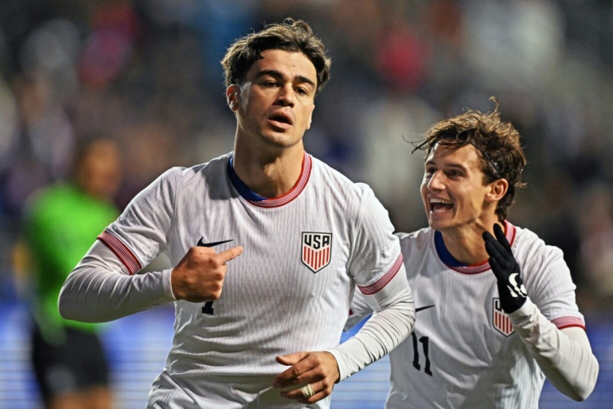 Gio Reyna and USA teammate Brenden Aaronson celebrate Reyna's first-half goal in the United States' 2-1 friendly football win over Paraguay
