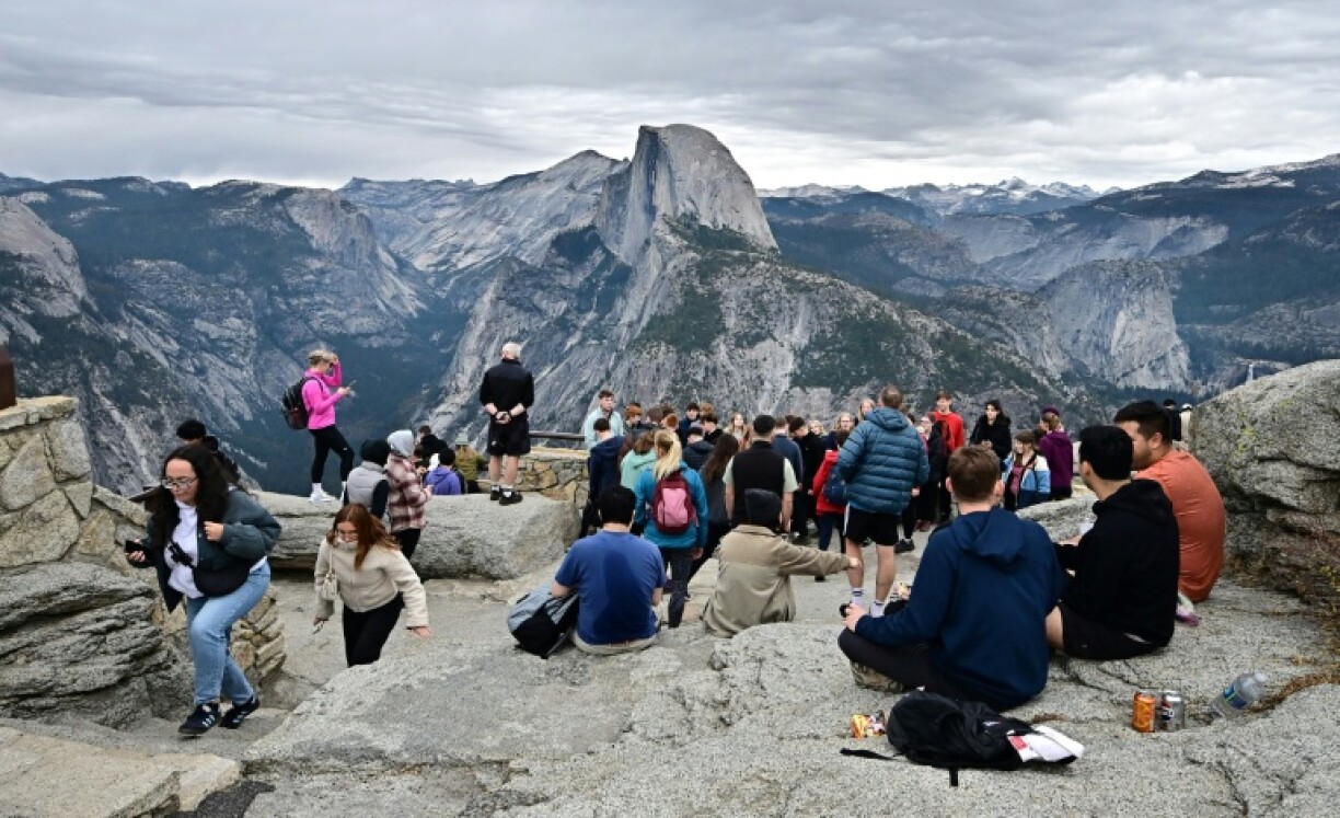 People enjoy the view of Half Dome from Glacier Point at Yosemite National Park