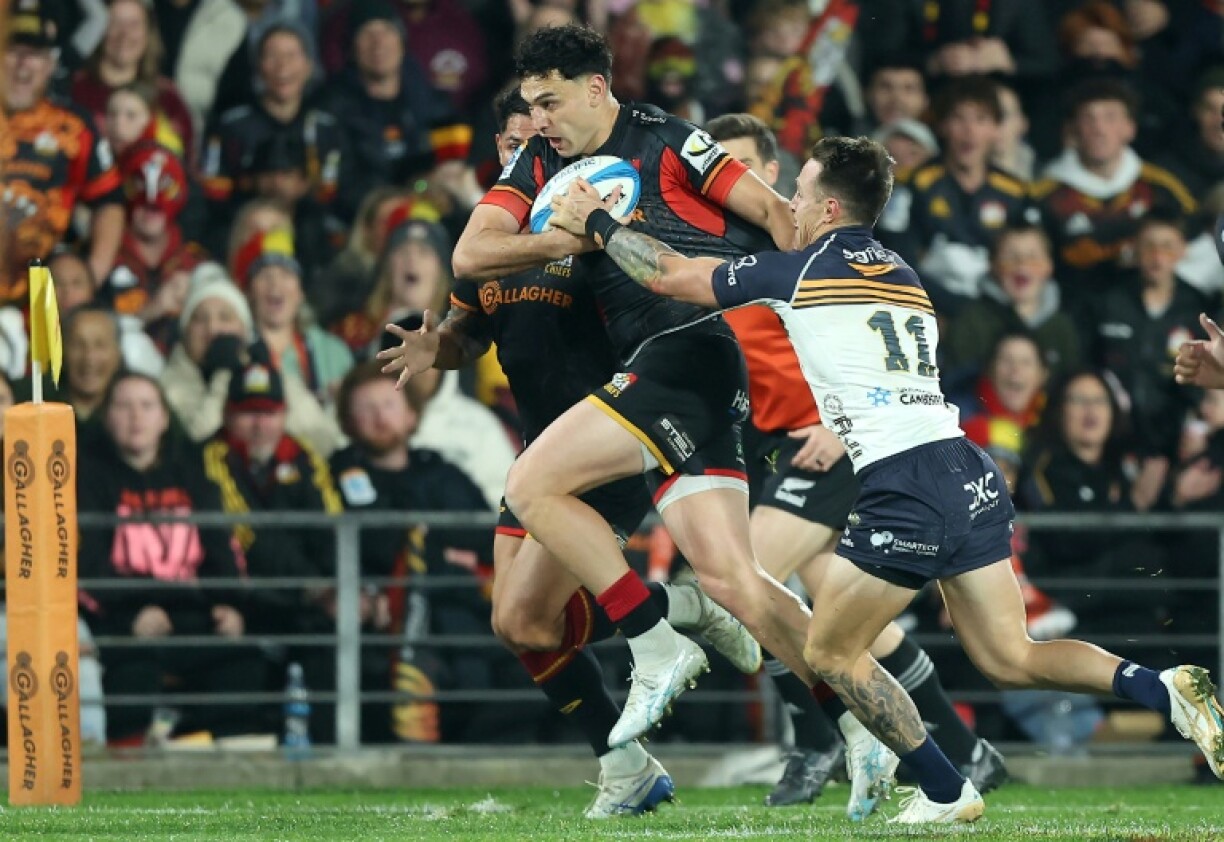 Shaun Stevenson (centre) of the Chiefs, here being tackled by Brumbies Corey Toole, is a doubt for the Super Rugby final