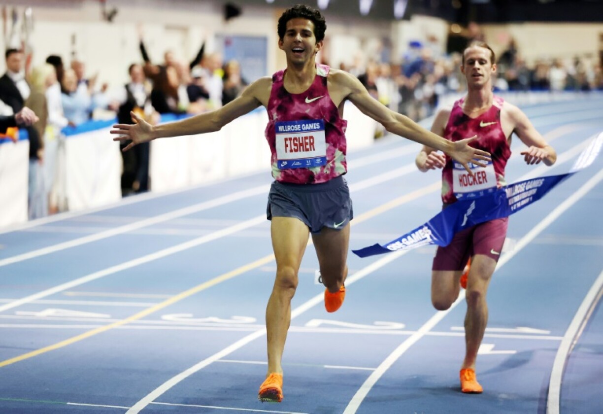 Grant Fisher crossed the line in a world-record-breaking win over Olympic 1,500m champion Cole Hocker in the 3,000m at the Millrose Games in New York on Saturday