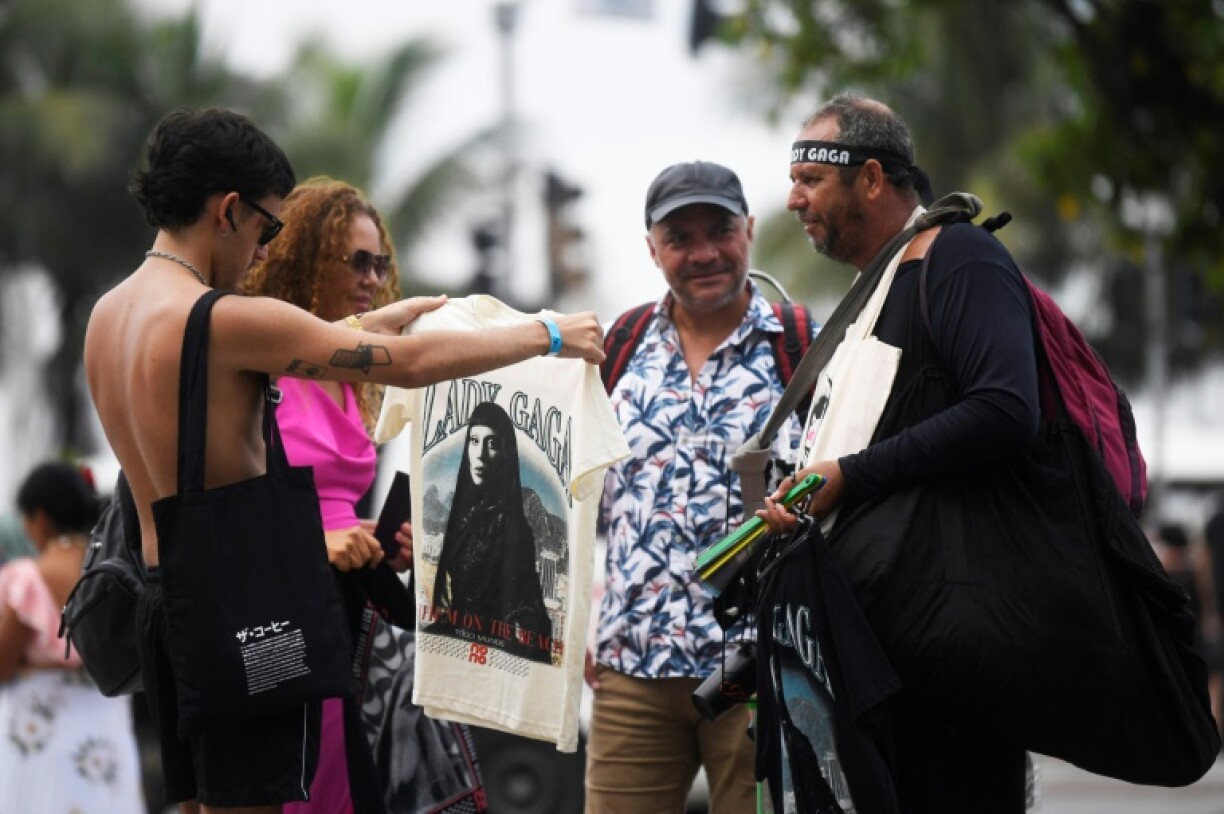 Tourists buy a Lady Gaga T-shirt in Rio ahead of her concert
