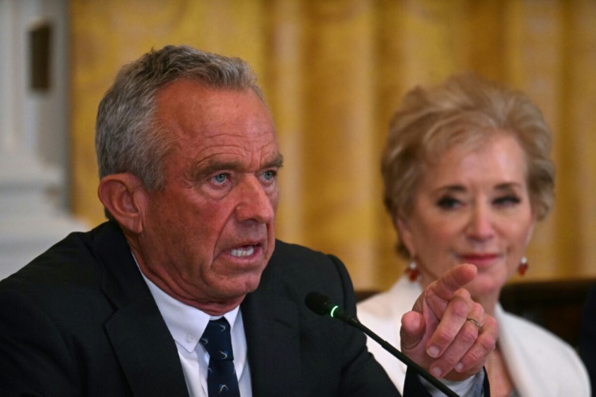 US Secretary of Health and Human Services Robert F. Kennedy Jr. (L) gestures as he speaks as US Secretary of Education Linda McMahon looks on during a MAHA (Make America Healthy Again) Commission Event in the White House