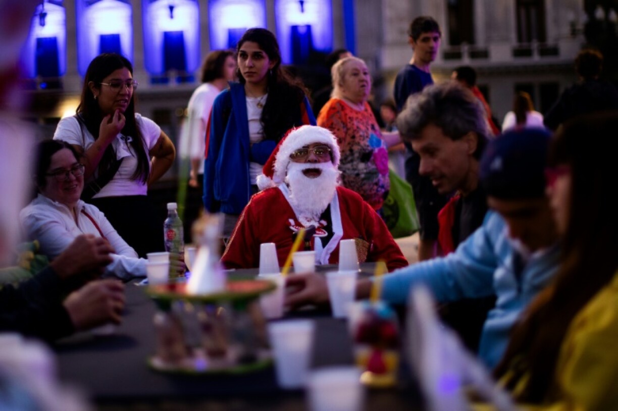 A man dressed as Santa Claus looks on as he takes part in a Christmas solidarity dinner called 'No Families Without Christmas' in front of the National Congress in Buenos Aires