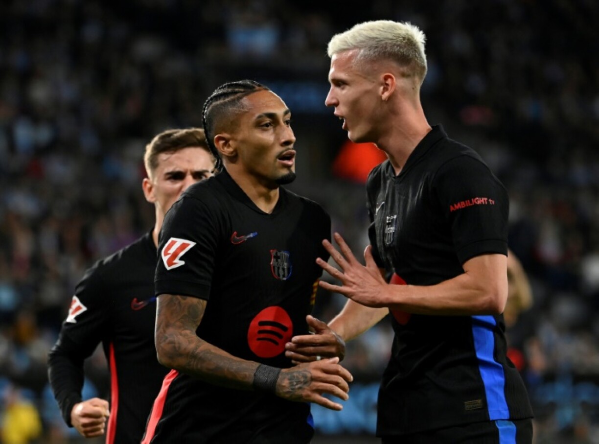 Barcelona's Brazilian forward Raphinha (C) celebrates with Dani Olmo (R)