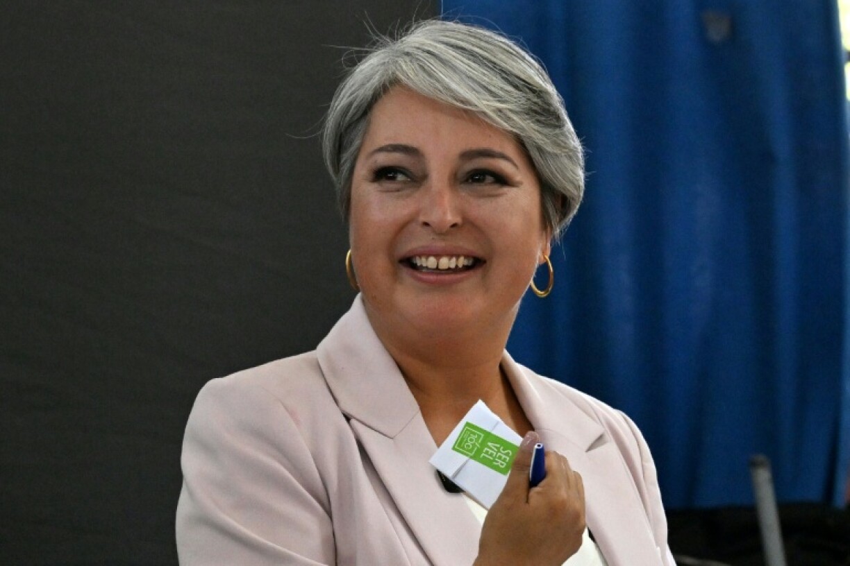 Chile's presidential candidate Jeannette Jara, of the Unidad por Chile coalition, shows her ballot before casting her vote