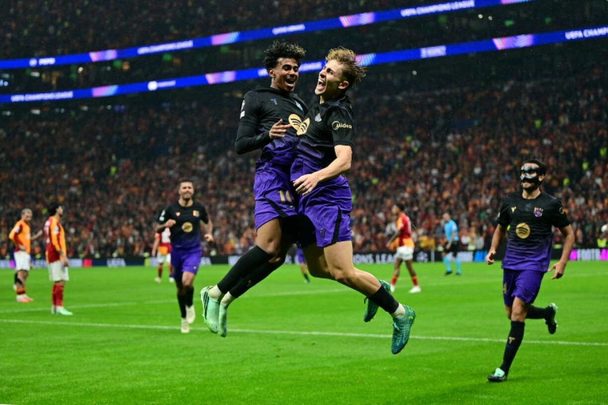Lamnine Yamal (centre left) celebrates with scorer Fermin Lopez (centre right) after setting up Barcelona's second goal in Istanbul