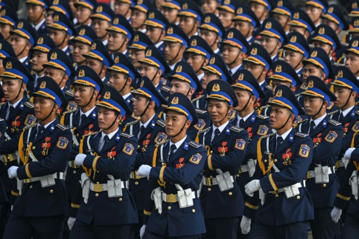 Around 40,000 troops and civilians began parading in the capital Hanoi after dawn