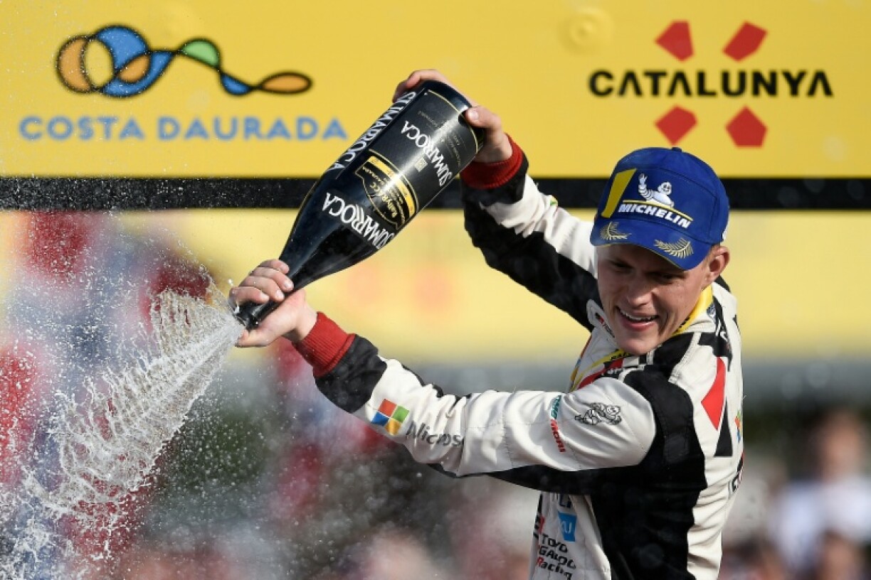 Ott Tanak cracks the champagne as he celebrates winning the 2019 World Rally Championship