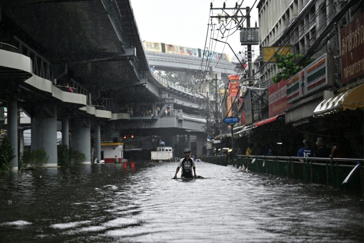 Residents navigate floodwaters and heavy rain in Bang Kapi district in Bangkok on September 28, 2026.
