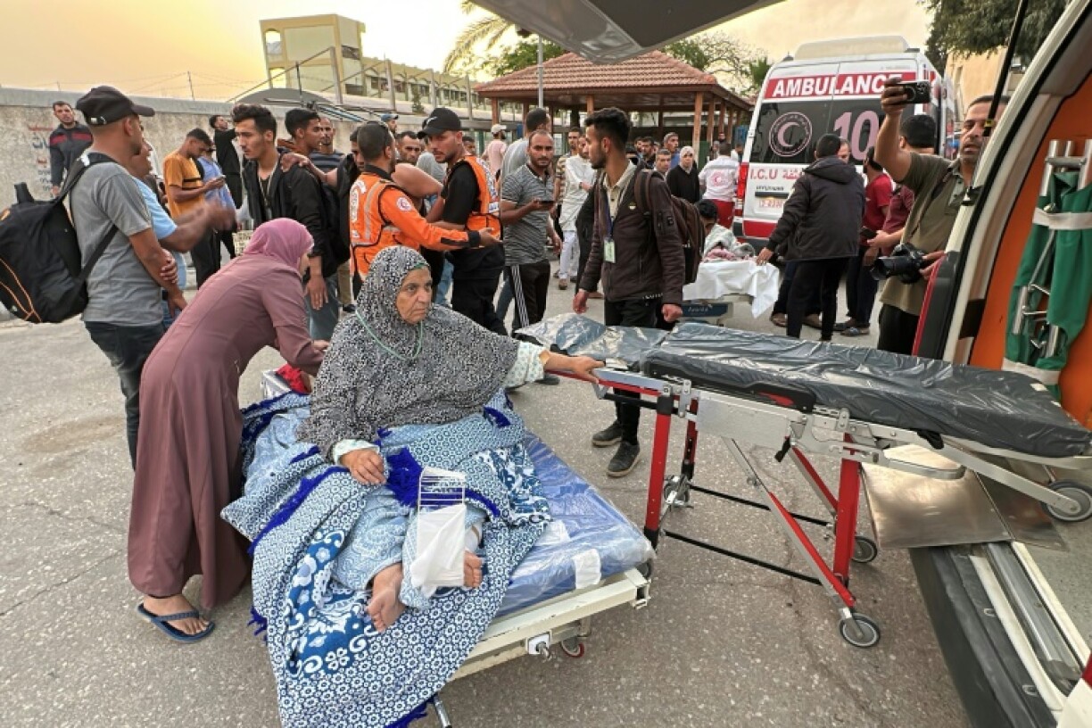 A woman in a hospital bed in assisted following an Israeli strike in Khan Yunis
