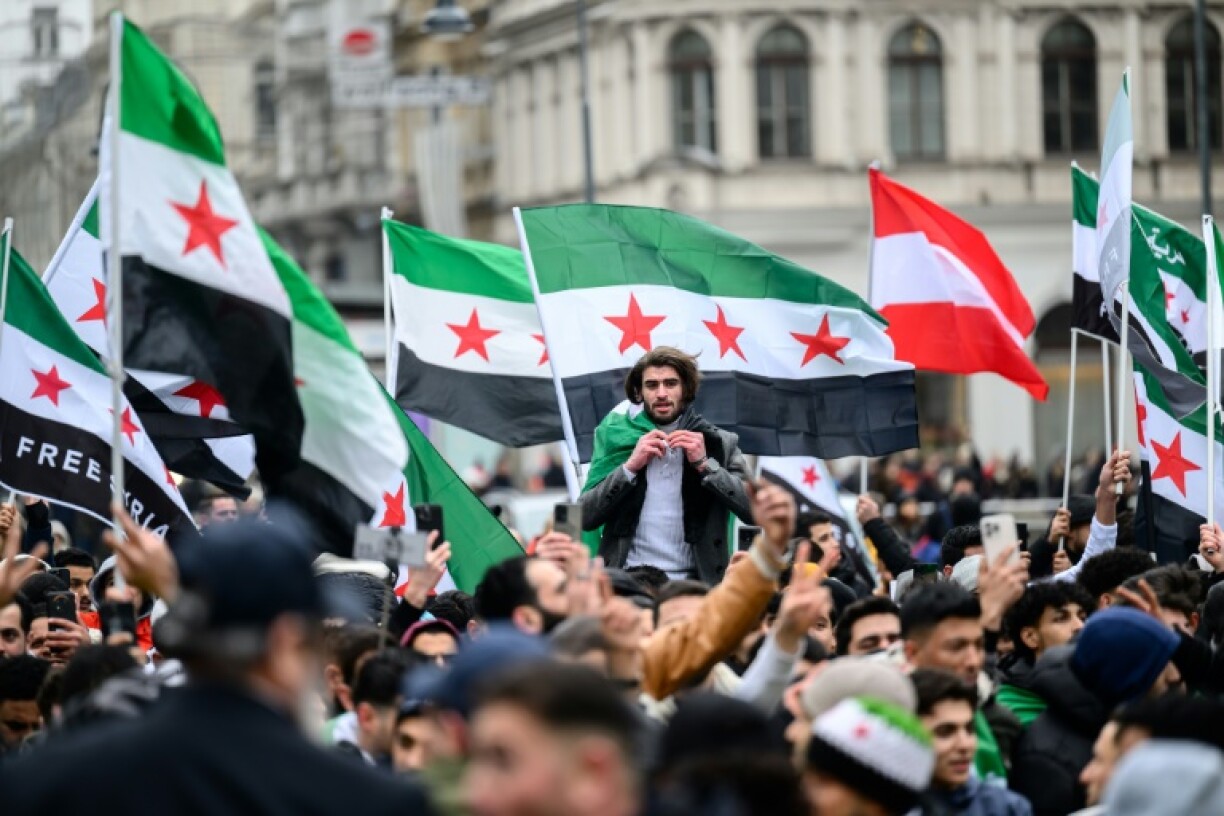 Syrians celebrate the fall of dictator Bashar al-Assad in Vienna in December