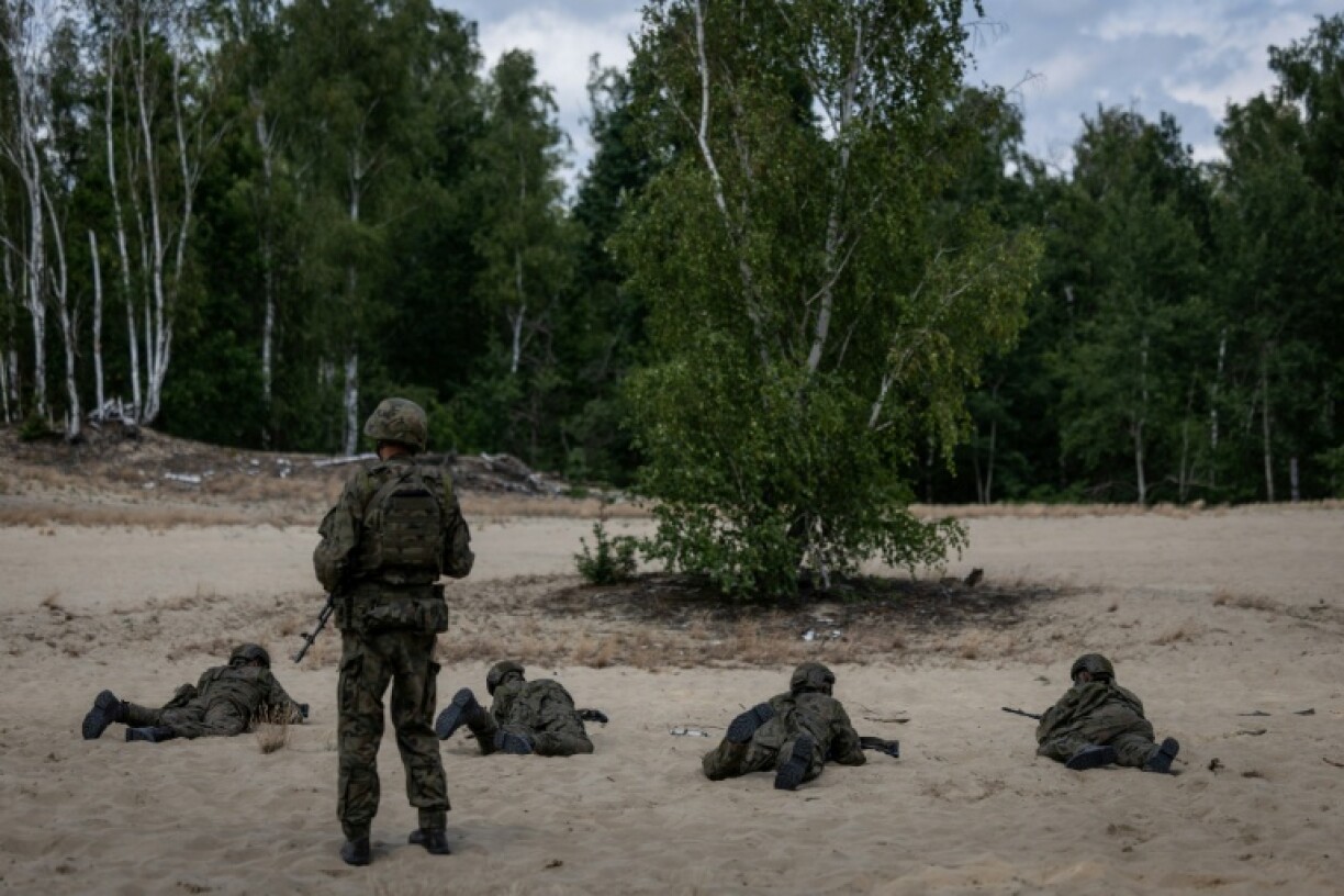 A military instructor keeps an eye on volunteers during a military training that is part of the