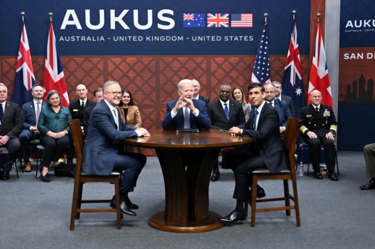 Former US president Joe Biden (C) participates in a 2023 AUKUS summit with then-British PM Rishi Sunak (R) and Australia's Anthony Albanese (L)