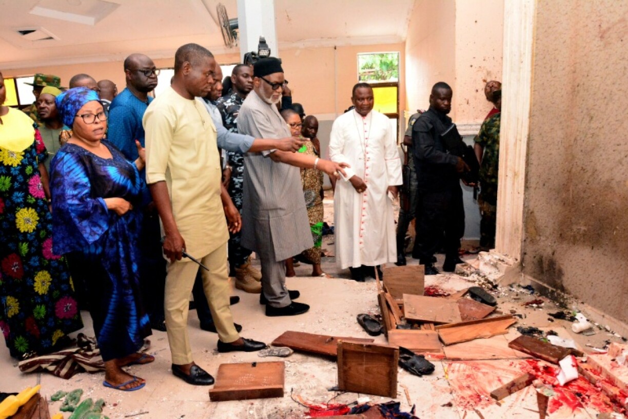 A Nigerian state official tours the church in June 2022 after gunmen killed at least 40 Catholic worshippers
