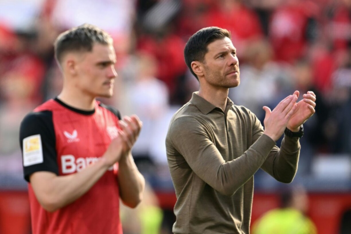 Bayer Leverkusen coach Xabi Alonso (R) and midfielder Florian Wirtz could make their last home appearances in Sunday's game with Dortmund