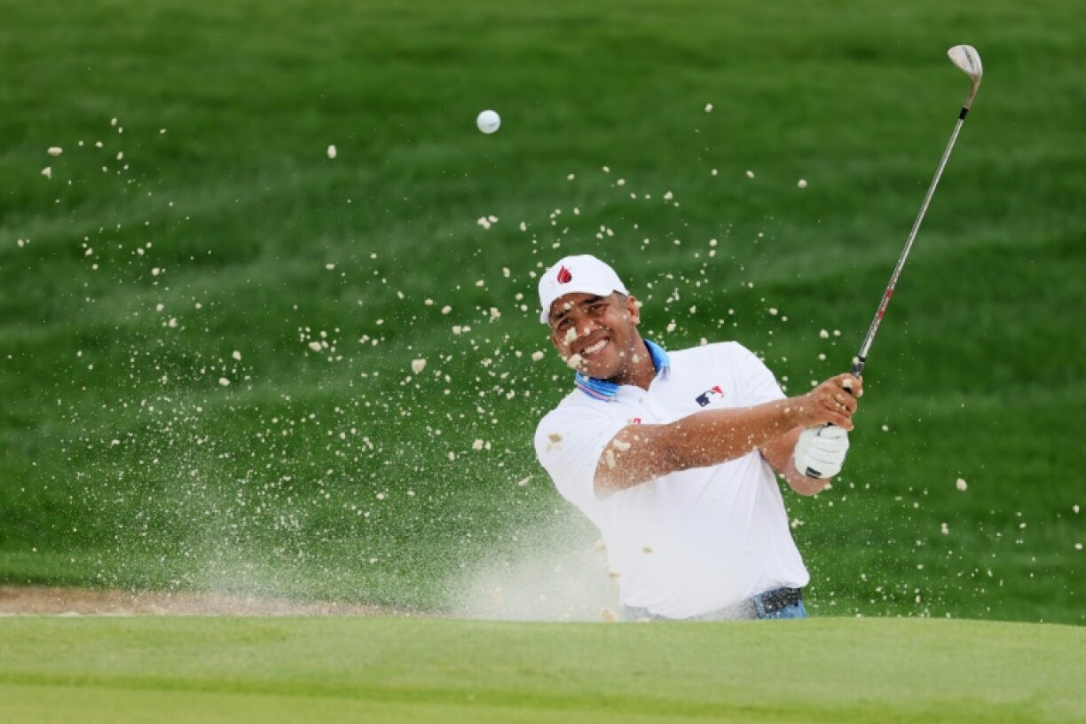 Venezuelan Jhonattan Vegas blasted out of a greenside bunker on 18 on his way to a double bogey but still led in the second round of the PGA Championship at Quail Hollow