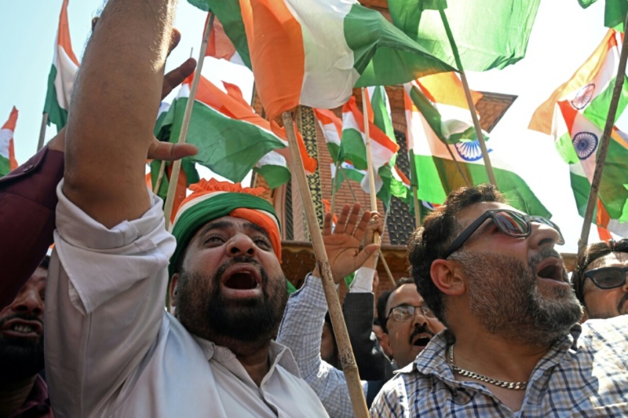 Supporters of India's Bharatiya Janata Party shout slogans and wave country's national flags as they take part in a rally expressing solidarity with the armed forces in Srinagar