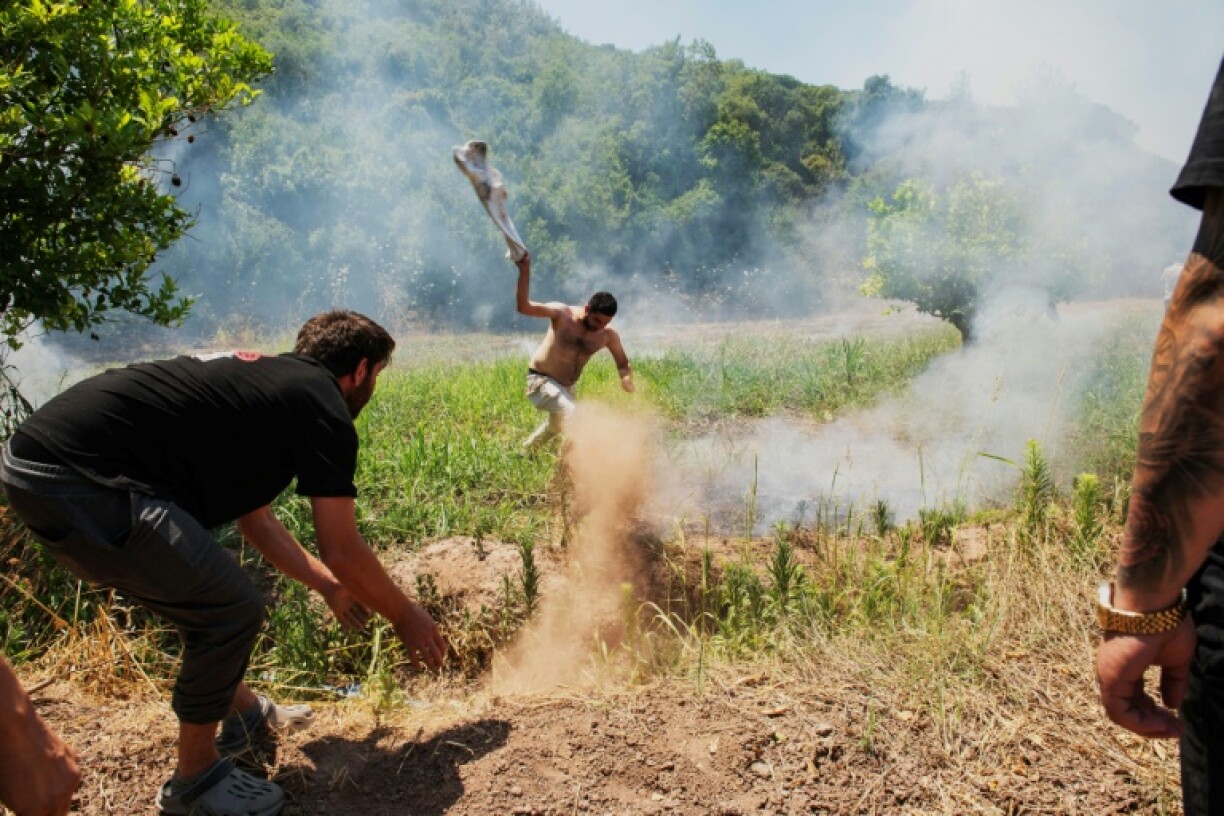Villagers try to put out the fire