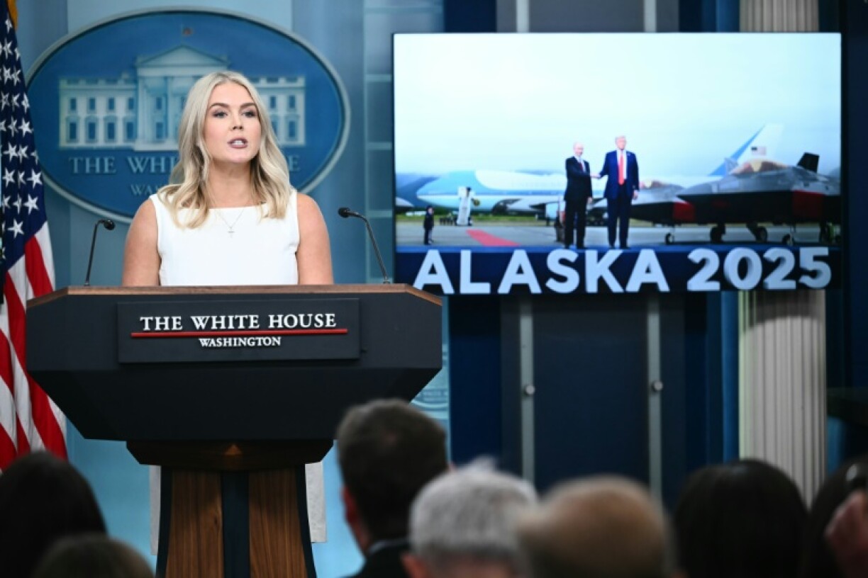An image of US President Donald Trump with Russian President Vladimir Putin is displayed on a screen as White House Press Secretary Karoline Leavitt speaks during the daily briefing at the White House on August 19, 2025