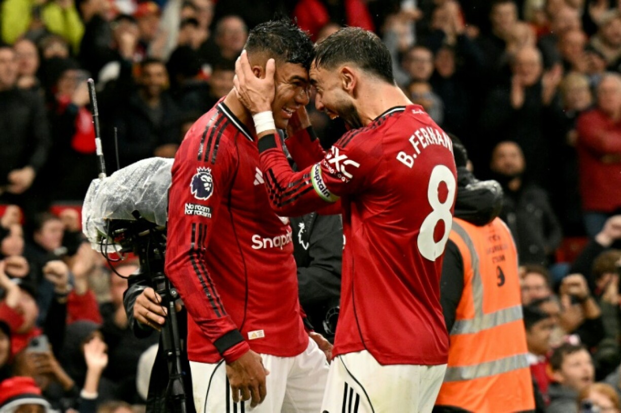 Manchester United's Casemiro (L) celebrates with Bruno Fernandes after scoring against Chelsea