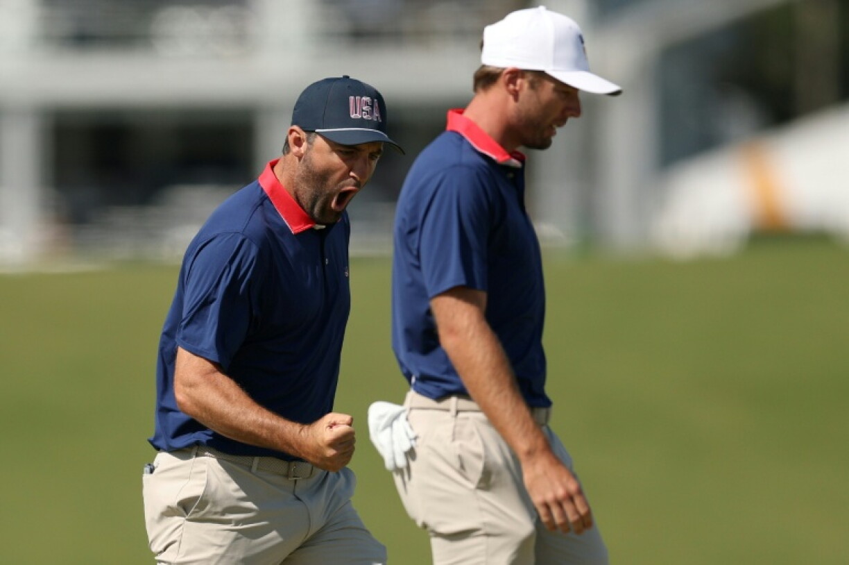 Top-ranked Scottie Scheffler, left, reacts alongside Sam Burns as the US duo won to lift within 8.5-5.5 at the Presidents Cup